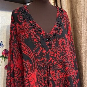 Elegant red and black floral semi-sheer blouse with a bat wing sleeve. Size 2X.